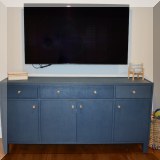 F17. Made Goods linen wrapped navy blue console table. 38”h x 76”w x 19”d 
